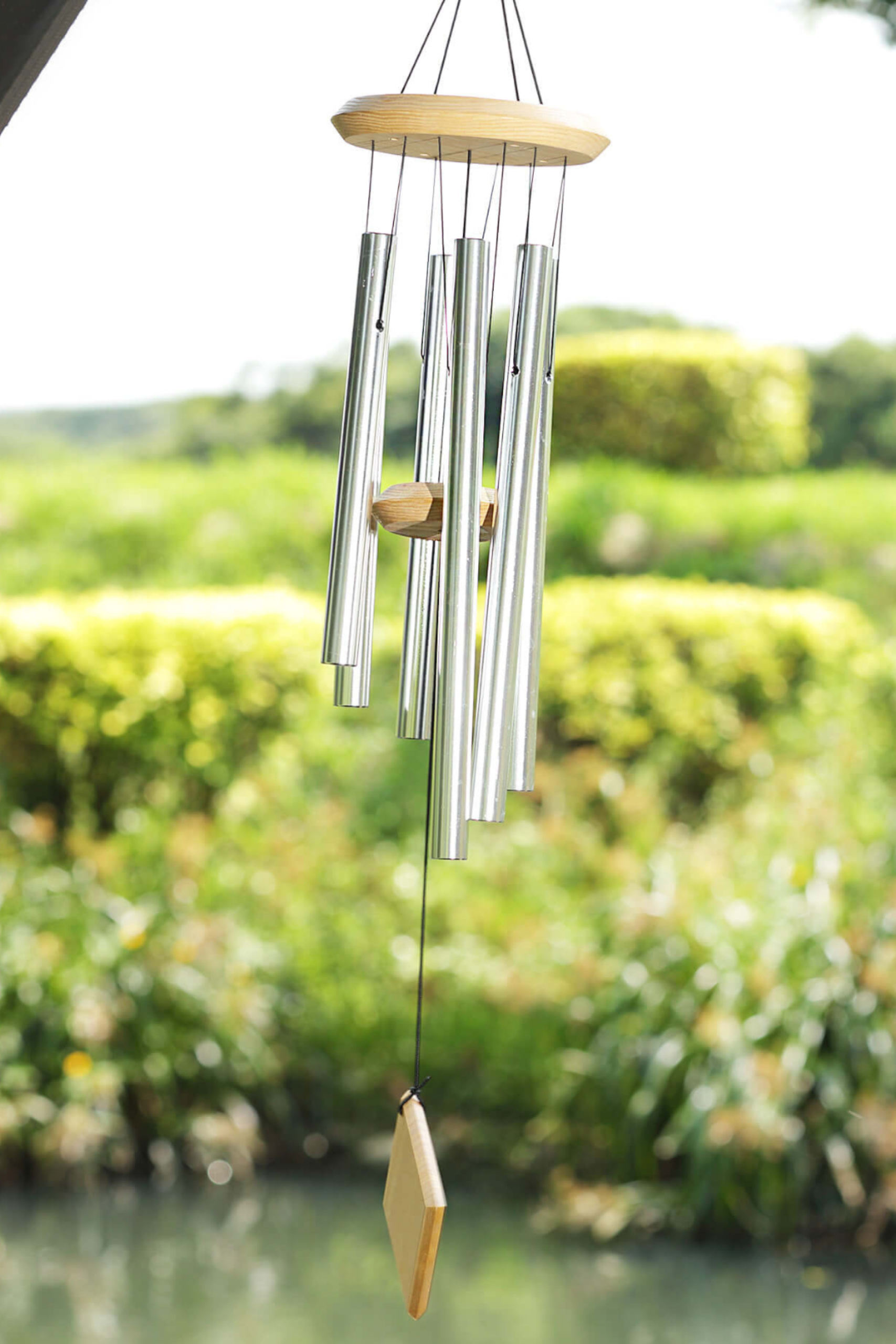 The Hand Painted Wood is the most special feature of this wind chime. It creates an extremely elegant look. The color of the wood and tubes can be customized. High quality solid wood A whole piece of solid wood is used for the wind chime top, striker, and wind catcher. Clear paint is applied on the wood so that the wood can be waterproof. The coating also sets off the beautiful texture of the wood. Untangled Strings and Strong hooks All parts of the wind chime are connected to a strong copper hook with durable double braided nylon string. The color of the hook and strings can be customized. The string does not get tangled. Calm and Melodic Tone High-quality aluminum tubes are used for our Wooden Reversed Stair Top Tuned Wind Chimes. Thick tube walls create an extraordinary tone; the sound is deep and calm. Aluminum made tubes create a sound that is clear but not sharp, they create unique tones different from iron or brass. Durable and Waterproof The top, striker, and sail are applied with waterproof coating, and the hook and tubes are anodized. This enables Wooden Top Tuned Wind Chimes to be put outdoors without becoming rusty. Listen the clear and melodic sound of Metal Ring Top Wind Chimes, and enjoy the harmony in the breeze!